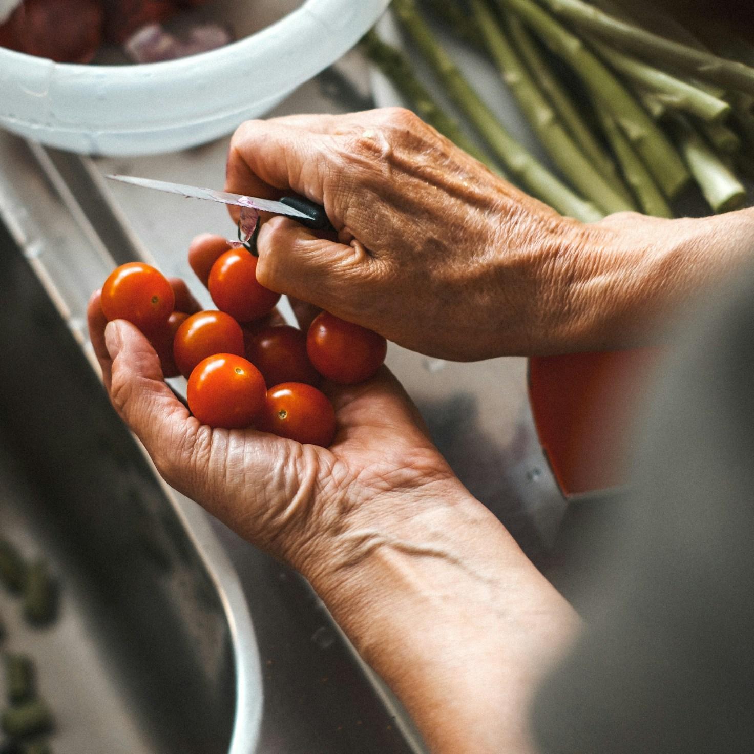 Community members collaborating in a contemporary kitchen, exchanging recipes and cooking techniques